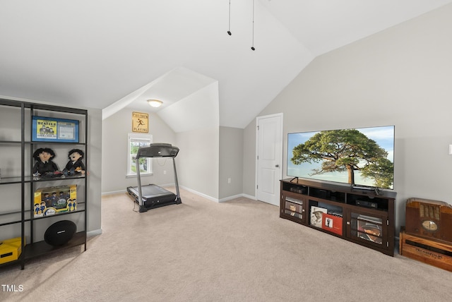 exercise room with carpet floors, lofted ceiling, and baseboards