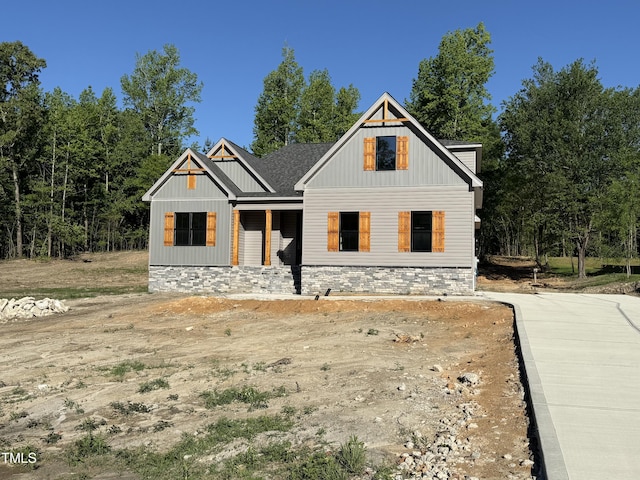 view of front of house featuring board and batten siding and stone siding