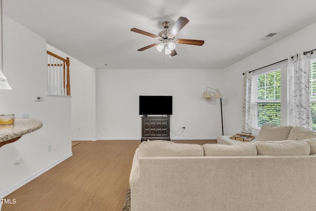 416 Durants Neck Ln, Morrisville, NC 27560 - living area with light wood finished floors, a ceiling fan, and baseboards