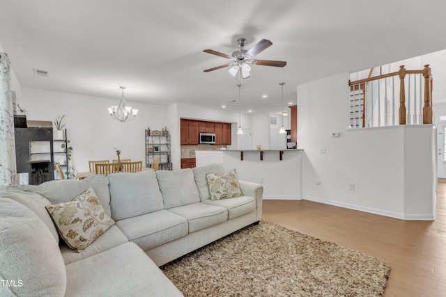 416 Durants Neck Ln, Morrisville, NC 27560 - living area featuring light wood-type flooring, a chandelier, a ceiling fan, baseboards, and recessed lighting