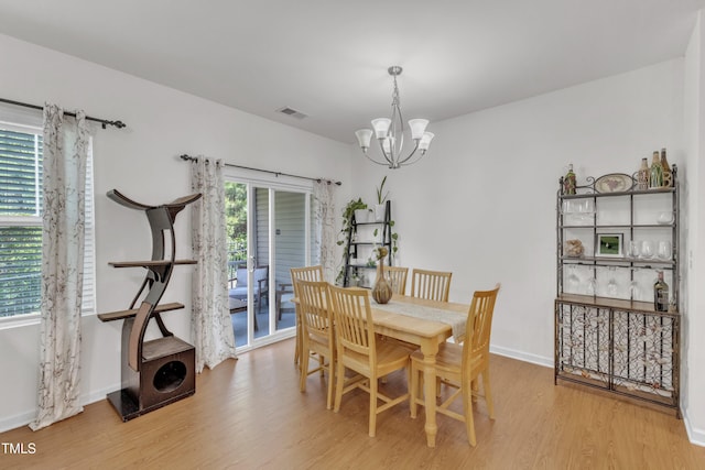 416 Durants Neck Ln, Morrisville, NC 27560 - dining area featuring a chandelier, light wood-style flooring, and baseboards