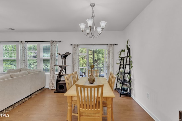 416 Durants Neck Ln, Morrisville, NC 27560 - dining room with a chandelier, wood finished floors, and baseboards