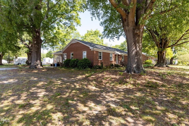 view of side of home with brick siding