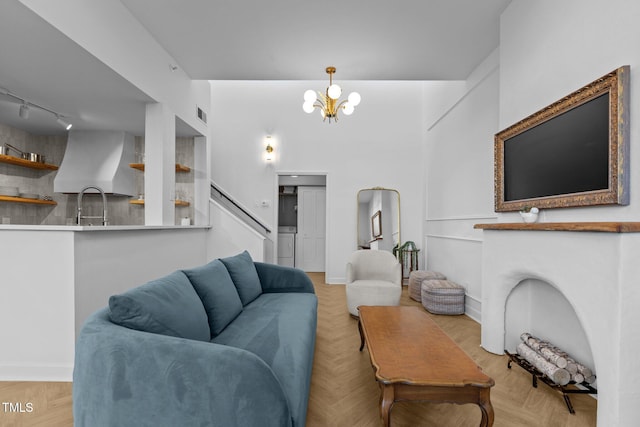 320 W Martin St Unit 205, Raleigh, NC 27601 - living area featuring rail lighting, a chandelier, stairs, and baseboards