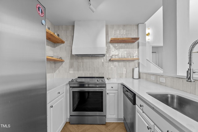 320 W Martin St Unit 205, Raleigh, NC 27601 - kitchen with open shelves, appliances with stainless steel finishes, wall chimney range hood, and a sink