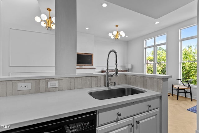 320 W Martin St Unit 205, Raleigh, NC 27601 - kitchen featuring a chandelier, a sink, black dishwasher, light countertops, and recessed lighting