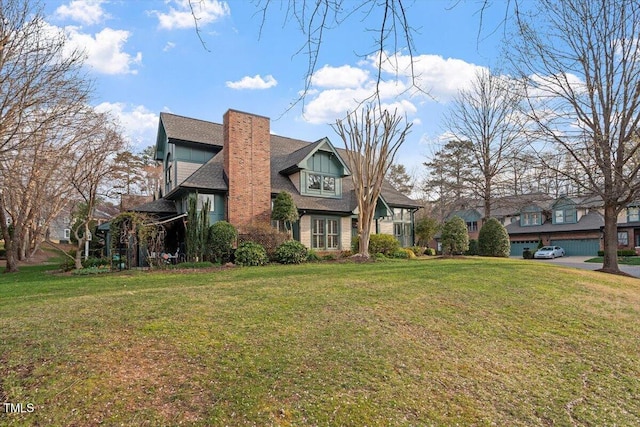 tudor-style house with a chimney and a front yard