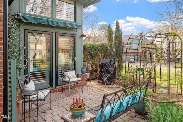 view of patio with a grill and fence