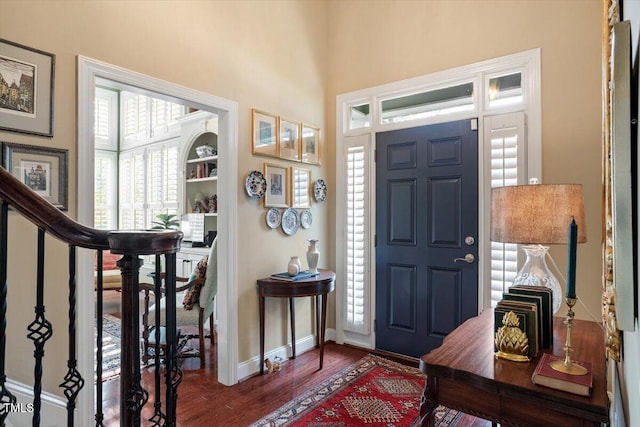 entryway featuring wood finished floors and baseboards