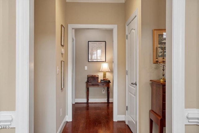 corridor with dark wood-style flooring and baseboards