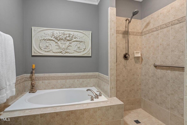 bathroom with tiled shower and a bath