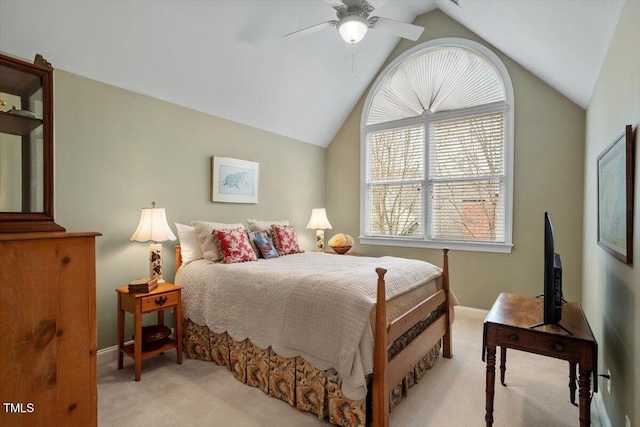 bedroom with light colored carpet, vaulted ceiling, baseboards, and a ceiling fan