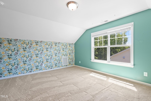 bonus room featuring vaulted ceiling, carpet floors, baseboards, and wallpapered walls