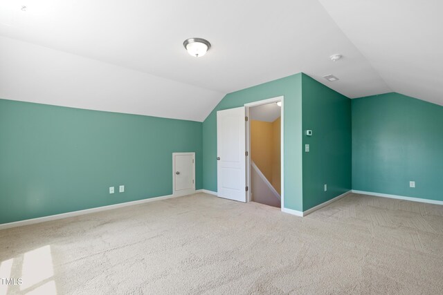 bonus room with vaulted ceiling, carpet floors, and baseboards