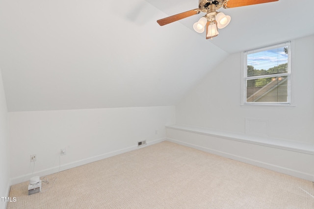 additional living space featuring carpet flooring, vaulted ceiling, baseboards, and ceiling fan