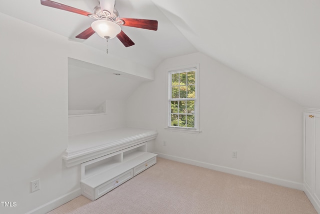 additional living space featuring lofted ceiling, carpet flooring, baseboards, and a ceiling fan