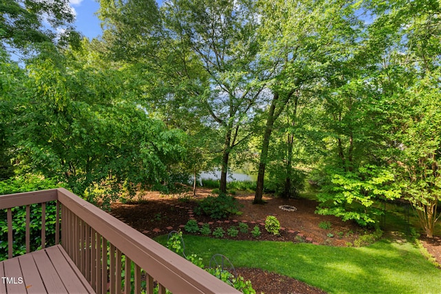 wooden terrace featuring a lawn