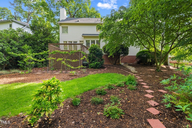 view of green lawn with a deck