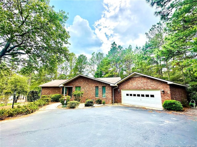 241 Firetree Ln, West End, NC 27376 - ranch-style home with an attached garage, brick siding, and driveway