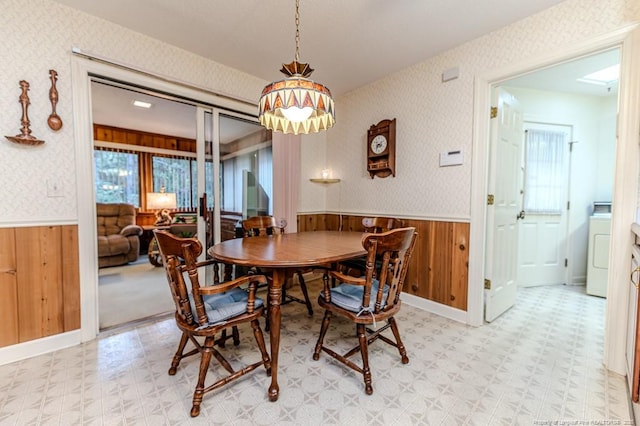 241 Firetree Ln, West End, NC 27376 - dining area with light floors, a wainscoted wall, washer / dryer, and wood walls