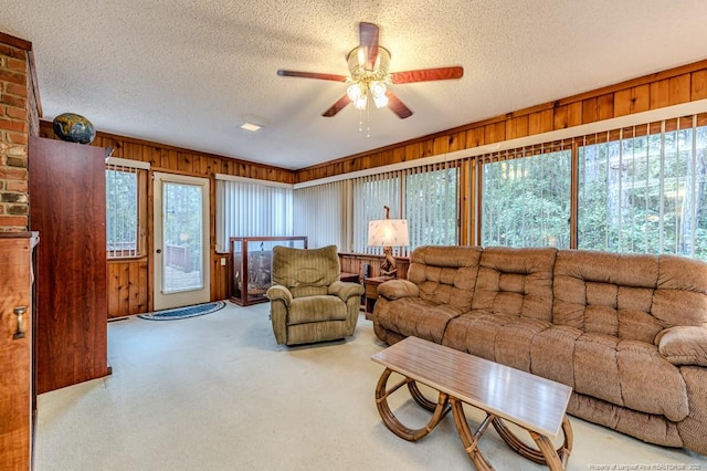 241 Firetree Ln, West End, NC 27376 - living room with carpet, a textured ceiling, wooden walls, and ceiling fan