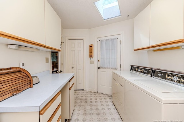 241 Firetree Ln, West End, NC 27376 - laundry area featuring light floors, a skylight, washing machine and dryer, and cabinet space
