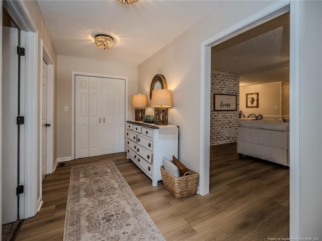 foyer entrance with baseboards and dark wood-style floors