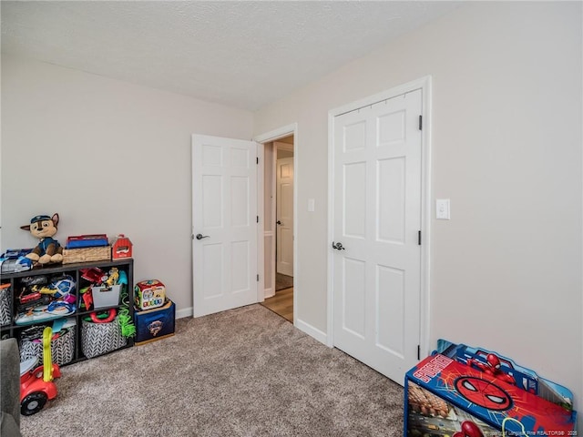 playroom with baseboards and carpet floors