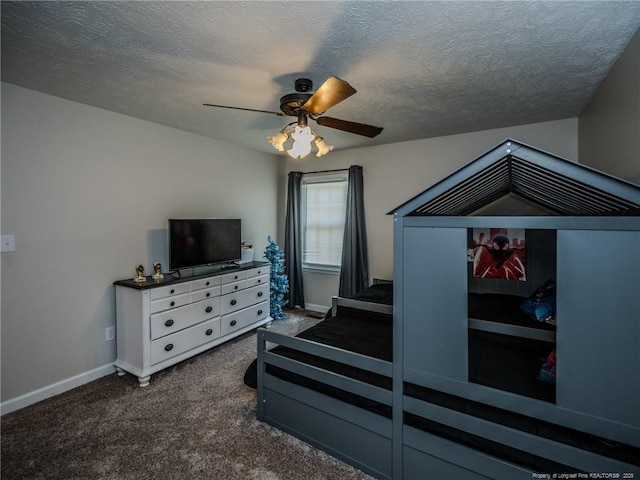 carpeted bedroom with a textured ceiling, baseboards, and a ceiling fan