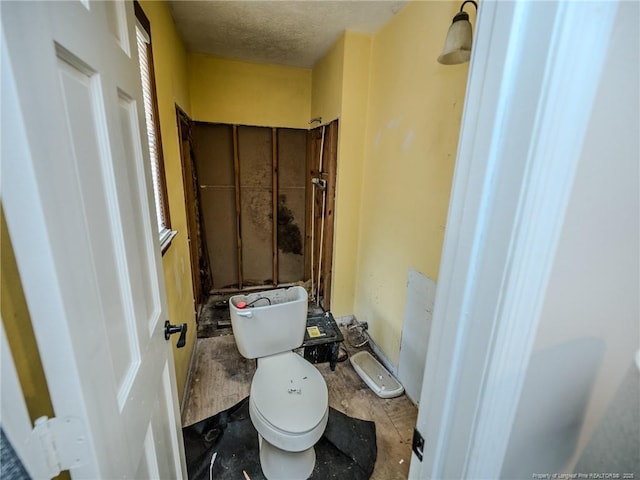 bathroom featuring toilet and a textured ceiling