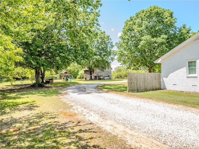 view of street with gravel driveway