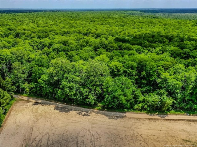 drone / aerial view featuring a view of trees