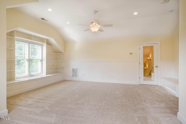 carpeted spare room featuring wainscoting, ceiling fan, recessed lighting, and lofted ceiling