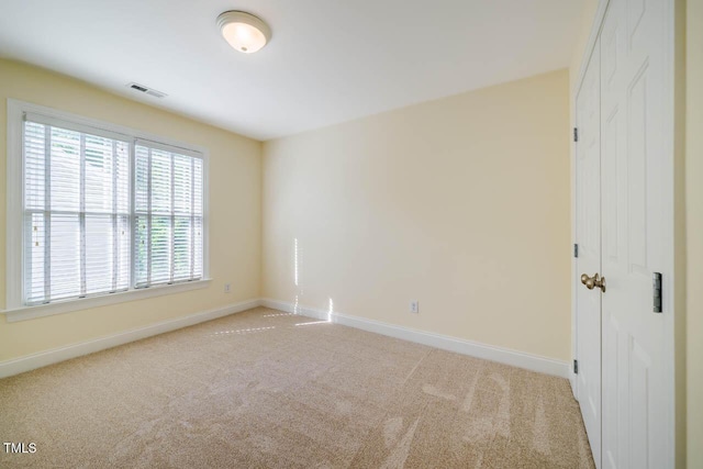 empty room with light carpet and baseboards