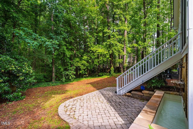 view of patio featuring a wooded view