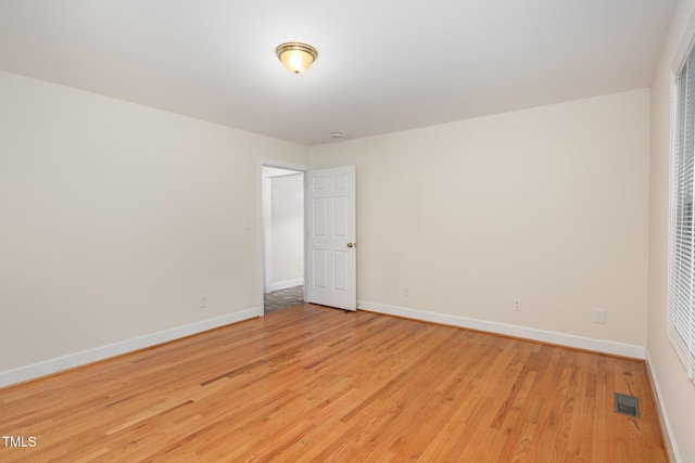 unfurnished bedroom with light wood-type flooring and baseboards