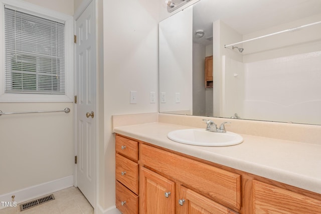 bathroom featuring tile patterned flooring, vanity, and baseboards