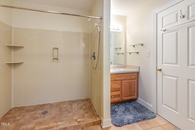 bathroom with vanity, a shower, and tile patterned floors