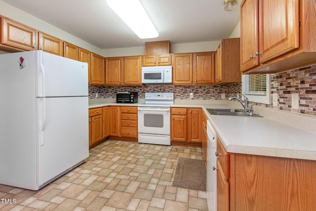 kitchen featuring white appliances, a sink, backsplash, light countertops, and brick patterned flooring