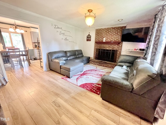 1305 Shakentown St, Knightdale, NC 27545 - living room featuring ornamental molding, wood finished floors, a fireplace, and a chandelier
