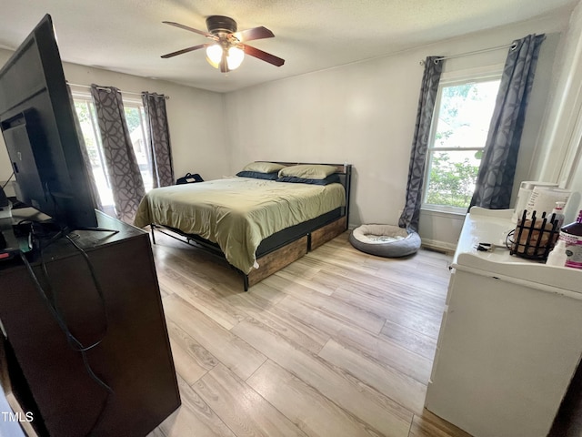 1305 Shakentown St, Knightdale, NC 27545 - bedroom featuring multiple windows, light wood finished floors, ceiling fan, and baseboards