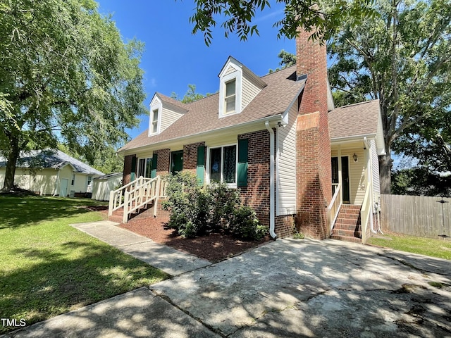 1305 Shakentown St, Knightdale, NC 27545 - new england style home featuring a chimney, a shingled roof, and brick siding