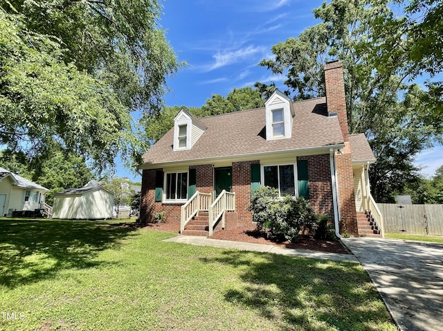 1305 Shakentown St, Knightdale, NC 27545 - cape cod-style house with brick siding, a chimney, a shingled roof, and driveway