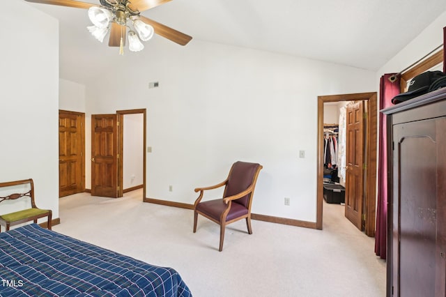 bedroom with baseboards, visible vents, a spacious closet, vaulted ceiling, and light carpet
