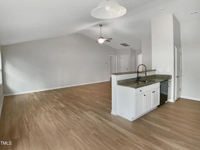 kitchen with baseboards, black dishwasher, visible vents, a sink, and wood finished floors