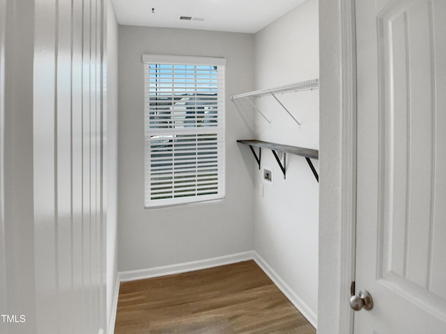 walk in closet featuring visible vents and wood finished floors