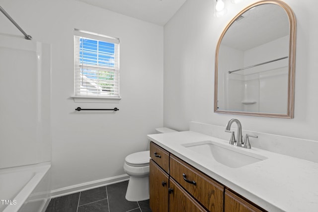 bathroom with tile patterned floors, toilet, vanity, baseboards, and shower / tub combination