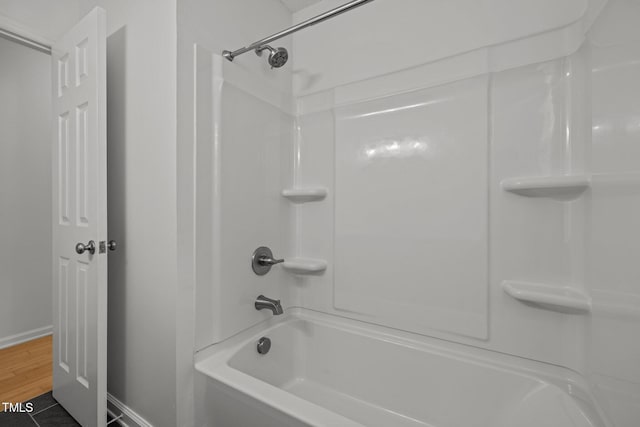 full bath featuring baseboards and wood finished floors