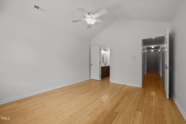 unfurnished bedroom with light wood-style floors, high vaulted ceiling, ensuite bathroom, baseboards, and ceiling fan