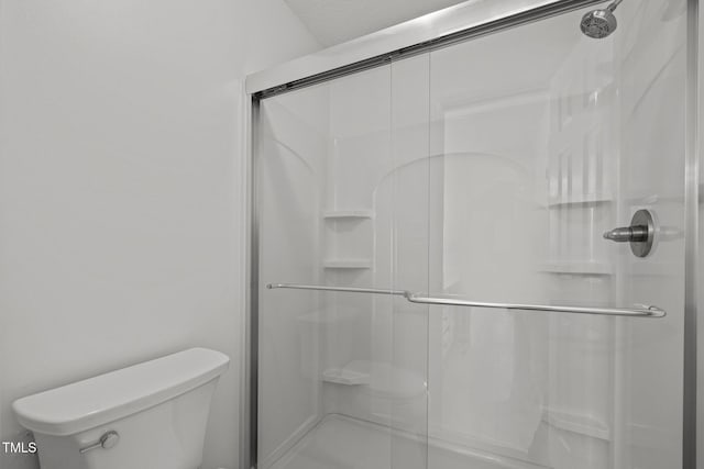 full bath with a shower stall and toilet
